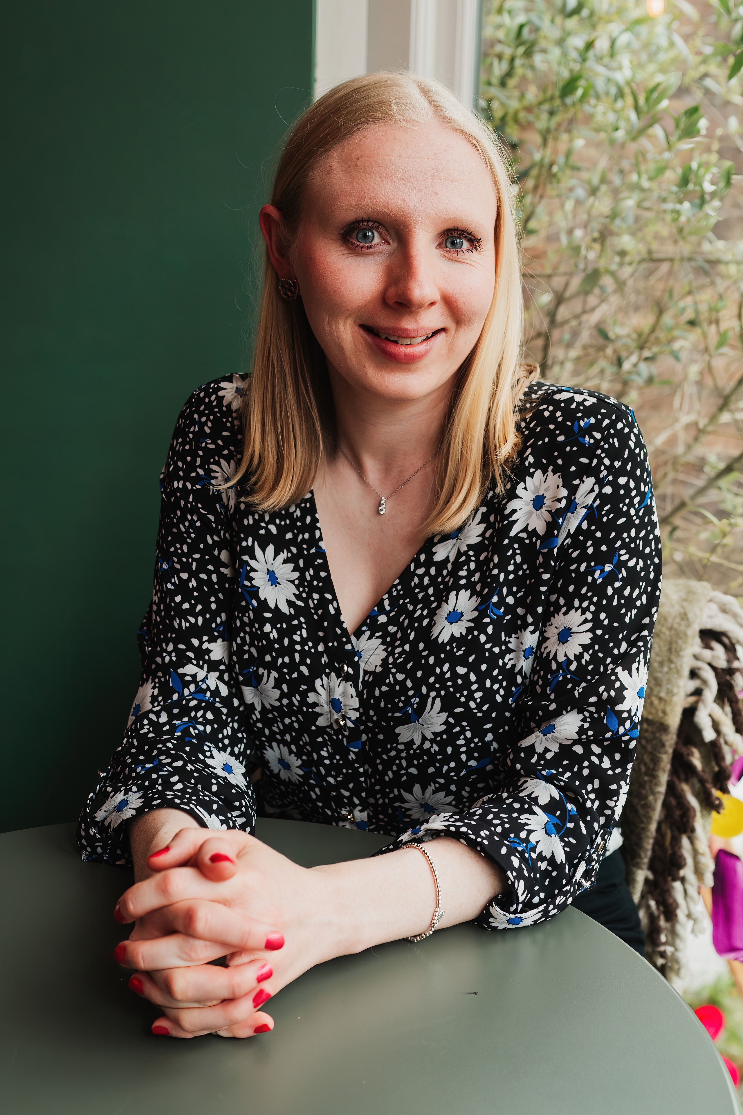 Hannah Pritchard, HCPC Registered Dietitian, smiling at a café table
